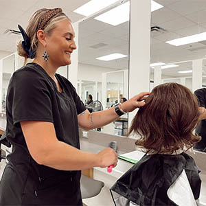 Cosmotology student practicing on practice model