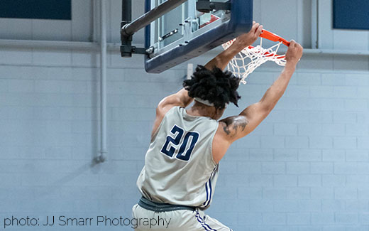Basketball player mid-slam-dunk. Photo Credit: JJ Smarr Photography